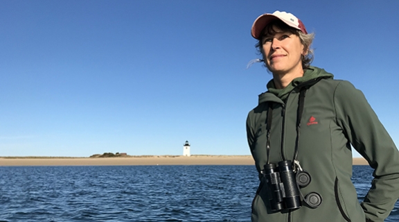 Elizabeth Bradfield with water and lighthouse in background